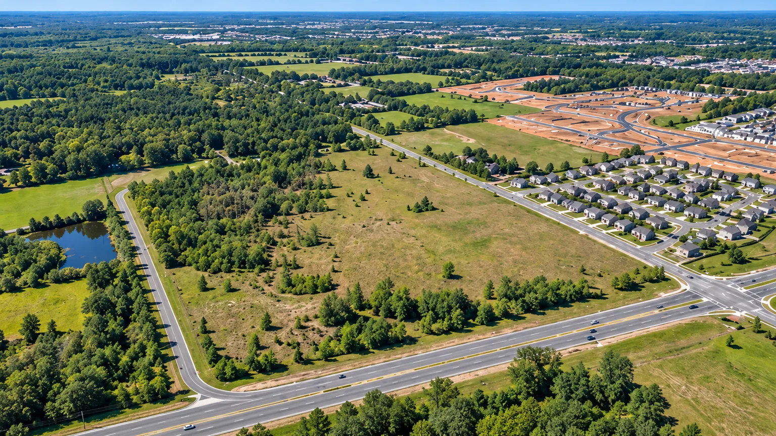 Conceptual aerial landscape of undeveloped land beside an expanding community